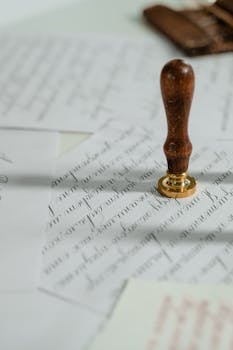 Notary Public y Servicios de Documentación Vintage calligraphy papers with a wooden wax seal stamp, embodying timeless elegance.